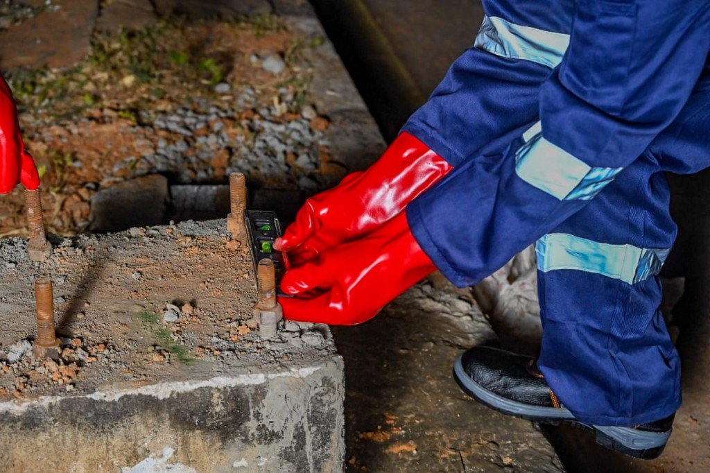 A trainee setting a foundation true with a spirit level